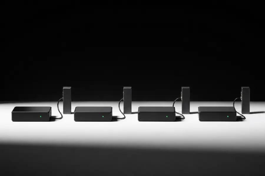 A row of identical sending machines, each showing a green status light